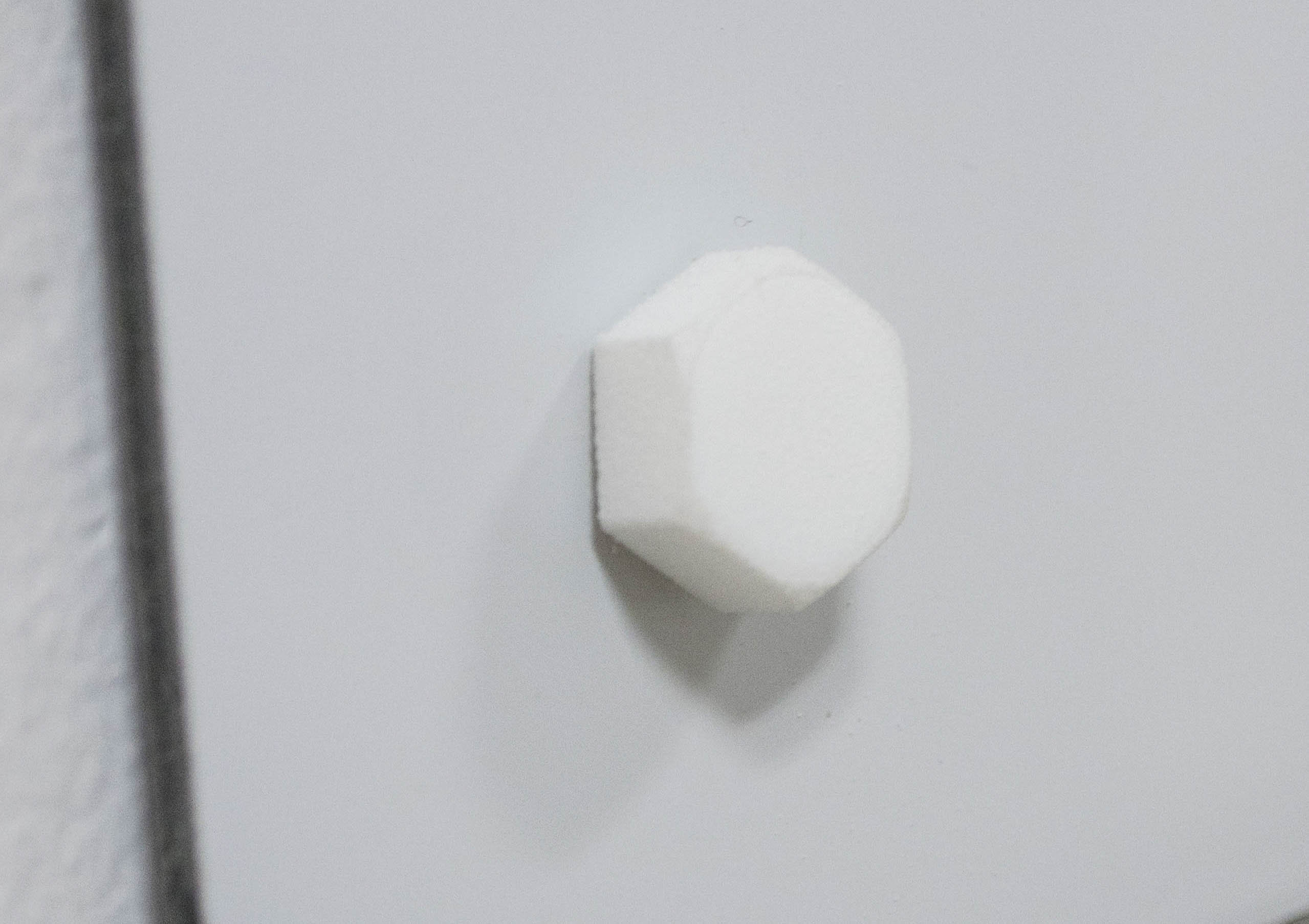 Retained Obstruction No.1, 2014 125 x 125 cm Dibond, Pulled off plastic protector, 3 hexagonal M10 screws, 1 3D printed hexagonal M10 screw, remains of wall dus
